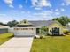 Charming home with a well-manicured lawn, two-car garage, and inviting curb appeal at 11630 Pasadena Rd, Dade City, FL 33525