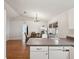 Open kitchen layout with a view of the dining area and wood flooring at 11630 Pasadena Rd, Dade City, FL 33525