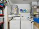 Functional laundry room with washer, dryer, water heater and storage shelves at 11630 Pasadena Rd, Dade City, FL 33525