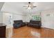 Living room with hardwood floors, comfortable leather seating, and a view of the doorway at 11630 Pasadena Rd, Dade City, FL 33525