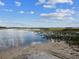 The home's prime location offers serene views of a pristine waterfront landscape with clear, open water at 11630 Pasadena Rd, Dade City, FL 33525