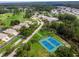 This aerial view shows community amenities including tennis courts, the community center, and single Gathering homes at 11814 Carissa Ln, New Port Richey, FL 34654