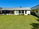 Spacious backyard with a well-maintained lawn, perfect for outdoor entertaining, with the house in the background at 11814 Carissa Ln, New Port Richey, FL 34654