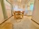 Inviting dining room with carpet, chandelier, and a view into the kitchen at 11814 Carissa Ln, New Port Richey, FL 34654