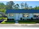 Charming single-story home featuring a well-manicured lawn and blue metal roofing at 11814 Carissa Ln, New Port Richey, FL 34654