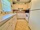 Cozy kitchen with white appliances, tile flooring, and ample cabinet space at 11814 Carissa Ln, New Port Richey, FL 34654