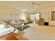 Bright living room featuring multiple seating options and a ceiling fan at 11814 Carissa Ln, New Port Richey, FL 34654
