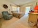 Cozy bedroom with direct access to the lanai, a recliner, and neutral-toned decor at 11814 Carissa Ln, New Port Richey, FL 34654