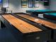 Multiple shuffleboard tables offer recreational opportunities for residents in a well-lit common area at 11814 Carissa Ln, New Port Richey, FL 34654
