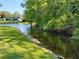 Scenic waterfront view with lush greenery and calm waters, highlighting the tranquil setting of the property at 11814 Carissa Ln, New Port Richey, FL 34654
