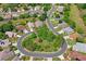 This aerial view shows the home in a circular neighborhood surrounded by mature trees at 11949 Wexford Blvd, Spring Hill, FL 34609