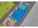 This aerial view shows the covered pool area, the blue awning, the pool, and the surrounding landscaping at 11949 Wexford Blvd, Spring Hill, FL 34609