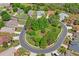 This aerial view shows the home in a circular neighborhood with mature trees and landscaping at 11949 Wexford Blvd, Spring Hill, FL 34609