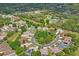 This aerial view shows the home in a circular neighborhood with mature trees, and an identifying arrow at 11949 Wexford Blvd, Spring Hill, FL 34609