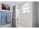 Bathroom featuring a shower and tub combination with blue and white accessories at 11949 Wexford Blvd, Spring Hill, FL 34609