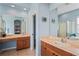 Bathroom featuring a tub, vanity, and mirrors with tile floors and a calming color scheme at 11949 Wexford Blvd, Spring Hill, FL 34609