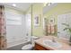Well-lit bathroom with a tiled shower and tub combination, complemented by a decorative seashell shower curtain at 11949 Wexford Blvd, Spring Hill, FL 34609