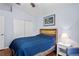 This bedroom has a bed, an end table, a window, hardwood floors, and a closet at 11949 Wexford Blvd, Spring Hill, FL 34609