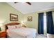 Cozy bedroom with a comfortable bed, side tables, and a window dressed with dark blue curtains at 11949 Wexford Blvd, Spring Hill, FL 34609