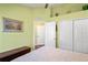 Bedroom featuring a bed, closet, and a neutral carpet, illuminated by soft lamp lighting at 11949 Wexford Blvd, Spring Hill, FL 34609