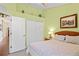 Bedroom showcasing a bed, closet, and a neutral carpet, illuminated by soft lamp lighting at 11949 Wexford Blvd, Spring Hill, FL 34609