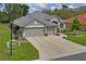 Charming single-story home with well-maintained lawn, attractive landscaping, and three-car garage at 11949 Wexford Blvd, Spring Hill, FL 34609