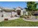 Attractive single-story home with a well-maintained lawn, garden, and brick walkway at 11949 Wexford Blvd, Spring Hill, FL 34609