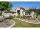 Lush landscaping surrounds this house, with colorful plants, shrubbery, and a walkway to the front door at 11949 Wexford Blvd, Spring Hill, FL 34609