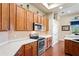 Well-appointed kitchen featuring stainless steel appliances, wood cabinets, and quartz countertops at 11949 Wexford Blvd, Spring Hill, FL 34609