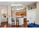 Bright, open kitchen with wood cabinets, stainless steel appliances, and a breakfast bar with seating at 11949 Wexford Blvd, Spring Hill, FL 34609