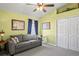 This living room features a gray couch, light-green walls, and a window with dark-blue curtains at 11949 Wexford Blvd, Spring Hill, FL 34609
