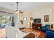 Comfortable living room with sliding glass doors to the pool and a ceiling fan at 11949 Wexford Blvd, Spring Hill, FL 34609