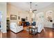 Spacious living room with ceiling fan, hardwood floors, and archways at 11949 Wexford Blvd, Spring Hill, FL 34609