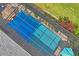 Aerial view of a screened-in pool surrounded by lush landscaping and patio furniture, offering outdoor enjoyment at 11949 Wexford Blvd, Spring Hill, FL 34609