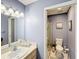 Functional bathroom featuring a shower with glass door, a toilet, and a vanity with a sink at 12545 Dearborn Dr # D, Bayonet Point, FL 34667