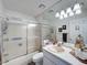 Bright bathroom with a mirrored wall and frosted glass shower at 12545 Dearborn Dr # D, Bayonet Point, FL 34667