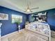 Cozy bedroom featuring a large window and modern ceiling fan at 12545 Dearborn Dr # D, Bayonet Point, FL 34667
