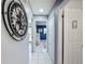 Hallway with white tile flooring, decor and view to another room at 12545 Dearborn Dr # D, Bayonet Point, FL 34667