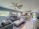 Open-concept living room with modern furnishings, tile floors, and abundant natural light at 12545 Dearborn Dr # D, Bayonet Point, FL 34667