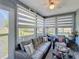 Bright sunroom with comfortable seating, large windows, and natural light at 12545 Dearborn Dr # D, Bayonet Point, FL 34667