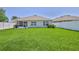 The expansive lawn leads to a back patio, perfect for outdoor relaxation and recreation at 13160 Golden Lime Ave, Spring Hill, FL 34609