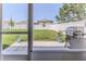 A paved lanai overlooks a large green lawn, enclosed by a white fence, with room for recreation and entertaining at 13160 Golden Lime Ave, Spring Hill, FL 34609