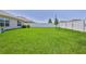 Large, well-maintained backyard featuring lush green grass and a privacy fence at 13160 Golden Lime Ave, Spring Hill, FL 34609