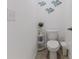 Clean bathroom with toilet, storage rack, and decorative fish wall art at 13160 Golden Lime Ave, Spring Hill, FL 34609