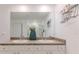 Bathroom featuring a double sink vanity, large mirror, and shower with glass doors at 13160 Golden Lime Ave, Spring Hill, FL 34609