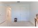 Bedroom with white walls, carpeted floor and two doors at 13160 Golden Lime Ave, Spring Hill, FL 34609