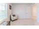 Bedroom with a chair, plantation shutters, and a neutral color scheme at 13160 Golden Lime Ave, Spring Hill, FL 34609