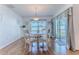 Cozy dining room with a round table, white chairs, and sliding glass doors to the outdoor patio at 13160 Golden Lime Ave, Spring Hill, FL 34609