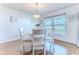 Bright dining room with a round table, comfortable chairs, and a window with a view at 13160 Golden Lime Ave, Spring Hill, FL 34609