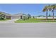Residential home featuring a manicured lawn and healthy palm tree at 13160 Golden Lime Ave, Spring Hill, FL 34609